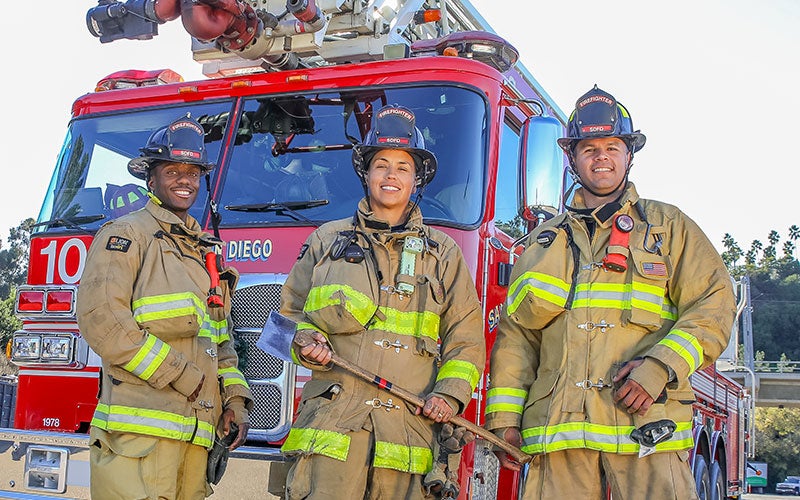 Photo of firefighters in front of firetruck